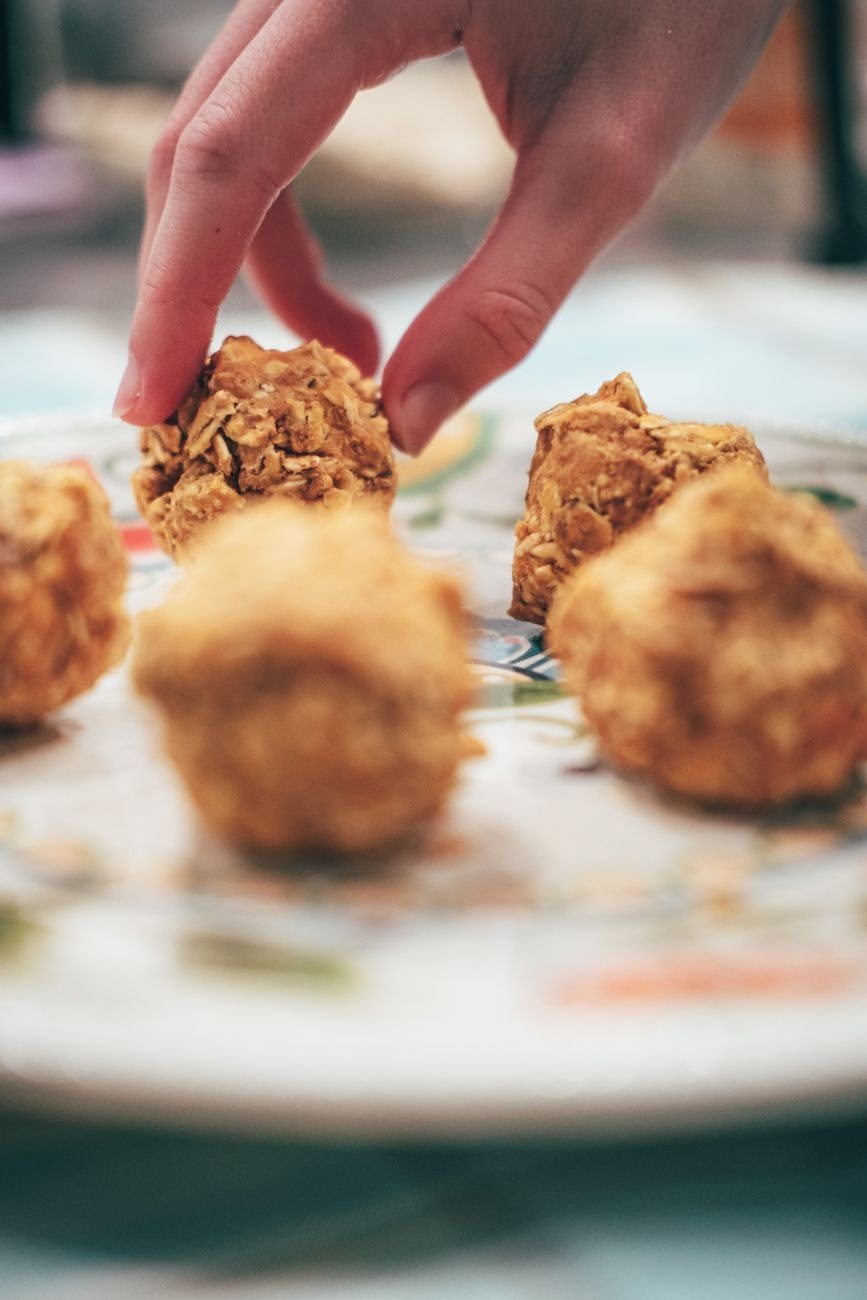 Hand Arranging Homemade Baked Snacks on a jigsaw puzzle