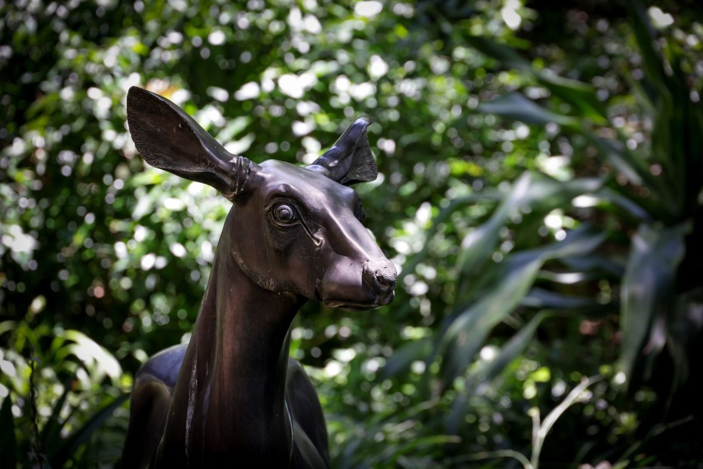 A Bronze Deer Sculpture Amidst Vibrant Garden jigsaw puzzle