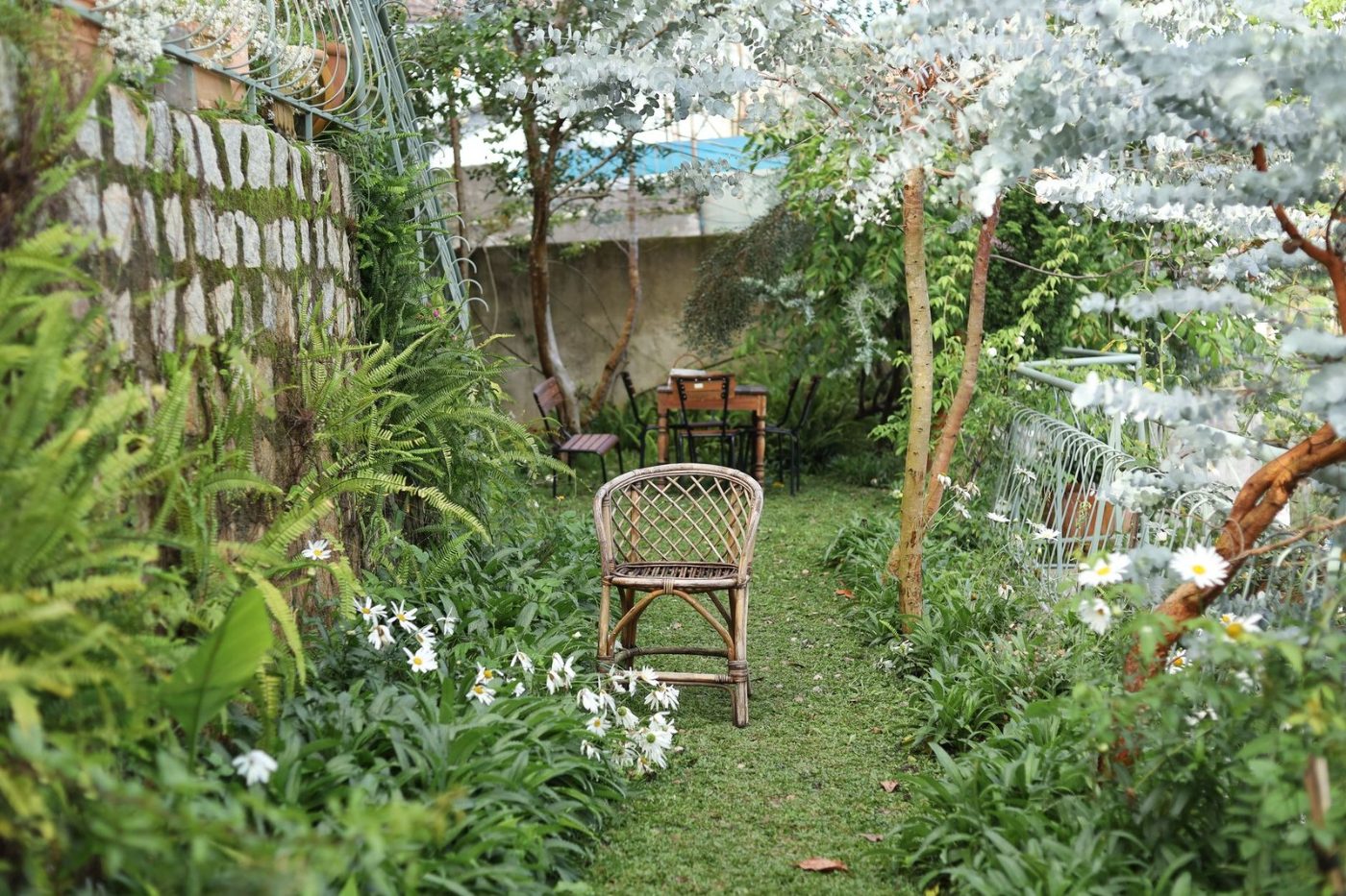 A Tranquil Garden Path with Wooden Chairs jigsaw puzzle