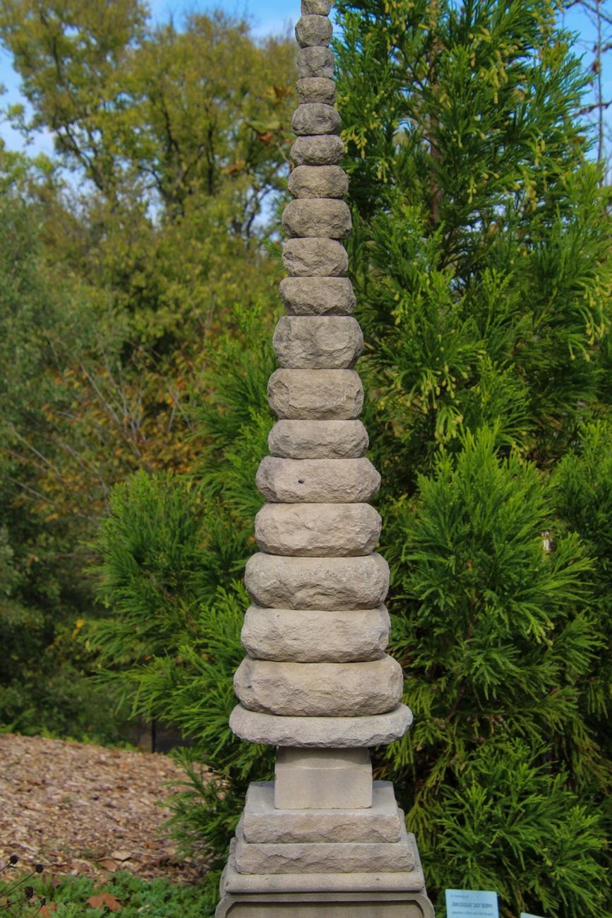 Tall Stone Pagoda Sculpture Surrounded by Lush jigsaw puzzle